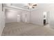 Large bedroom with tray ceiling, fan and ensuite bathroom and walk-in closet at 18041 W Ivy Ln, Surprise, AZ 85388