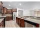 Spacious kitchen with stainless steel appliances, granite countertops, and dark wood cabinetry at 18041 W Ivy Ln, Surprise, AZ 85388