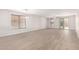 Bright living room featuring stylish wood-look flooring and neutral paint, with a sliding door leading to the backyard at 18041 W Ivy Ln, Surprise, AZ 85388