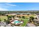 Community aerial featuring a pool, school, and green spaces at 19009 E Reins Rd, Queen Creek, AZ 85142