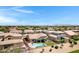 Drone image showcasing the backyard pool and surrounding neighborhood at 19009 E Reins Rd, Queen Creek, AZ 85142