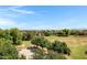 Aerial neighborhood view showcasing green spaces, a basketball court, and mature trees at 19009 E Reins Rd, Queen Creek, AZ 85142