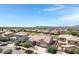 Aerial shot of a neighborhood featuring well-maintained homes, landscaping, and mountain views at 19009 E Reins Rd, Queen Creek, AZ 85142