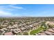 Expansive aerial shot showcasing neighborhood homes with pools and community green spaces at 19009 E Reins Rd, Queen Creek, AZ 85142