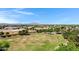 Aerial view of a school with athletic fields, a playground, and surrounding community at 19009 E Reins Rd, Queen Creek, AZ 85142