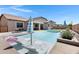 Gorgeous backyard featuring a sparkling pool, lounge chairs, and modern landscaping at 19009 E Reins Rd, Queen Creek, AZ 85142