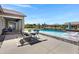 Beautiful backyard with pool, patio furniture, and lush landscaping at 19009 E Reins Rd, Queen Creek, AZ 85142