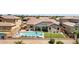 Beautiful backyard with a pool, patio, artificial grass, and outdoor seating at 19009 E Reins Rd, Queen Creek, AZ 85142
