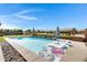 Stunning backyard with a large swimming pool, lounge chairs, and scenic views at 19009 E Reins Rd, Queen Creek, AZ 85142