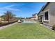 Beautiful backyard with a pool and ample space for outdoor entertaining at 19009 E Reins Rd, Queen Creek, AZ 85142