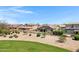 Backyard view of pool, artificial grass, and desert landscaping at 19009 E Reins Rd, Queen Creek, AZ 85142