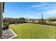 Beautiful backyard featuring a large artificial grass area and string lights at 19009 E Reins Rd, Queen Creek, AZ 85142
