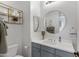 Modern bathroom featuring a round mirror, stylish fixtures, and decorative shelving at 19009 E Reins Rd, Queen Creek, AZ 85142