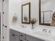 Bright bathroom featuring double sinks, stylish mirrors, and modern fixtures at 19009 E Reins Rd, Queen Creek, AZ 85142