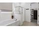 Bright bathroom featuring a soaking tub and a glass-enclosed shower and access to a walk-in closet at 19009 E Reins Rd, Queen Creek, AZ 85142