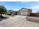Lovely single-Gathering home featuring desert landscaping and an extended concrete driveway at 19009 E Reins Rd, Queen Creek, AZ 85142