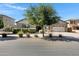 Beautiful home with manicured landscaping, a well-maintained lawn, and an attached two-car garage at 19009 E Reins Rd, Queen Creek, AZ 85142
