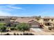 Charming single-Gathering home featuring neutral-toned stucco, well-maintained landscaping, and a two-car garage at 19009 E Reins Rd, Queen Creek, AZ 85142