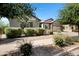 Inviting front yard with lush landscaping and a concrete walkway leading to a beautiful home at 19009 E Reins Rd, Queen Creek, AZ 85142