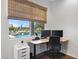 Office overlooking backyard pool area, with contemporary work station and white trim at 19009 E Reins Rd, Queen Creek, AZ 85142