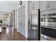 Stainless steel appliances accent this modern kitchen that includes grey cabinetry and hardwood floors at 19009 E Reins Rd, Queen Creek, AZ 85142