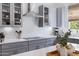 A bright kitchen features quartz countertops, stainless steel appliances, and modern gray cabinets at 19009 E Reins Rd, Queen Creek, AZ 85142