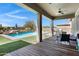 Inviting covered patio with wood flooring, ceiling fan, and outdoor seating area at 19009 E Reins Rd, Queen Creek, AZ 85142