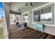Relaxing covered patio with wood flooring, ceiling fan, and outdoor cooler at 19009 E Reins Rd, Queen Creek, AZ 85142