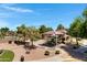 Community playground featuring shaded play structures, benches, and lush landscaping at 19009 E Reins Rd, Queen Creek, AZ 85142