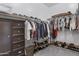 Well-organized walk-in closet with shelving and a dresser for ample storage at 19009 E Reins Rd, Queen Creek, AZ 85142