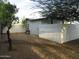 View of the backyard with desert landscaping and a white wooden fence at 1922 N 21St Pl, Phoenix, AZ 85006