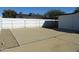 Expansive concrete area in the backyard bordered by a white fence and gravel, providing ample space at 1922 N 21St Pl, Phoenix, AZ 85006