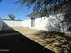 Enclosed backyard featuring a stone landscape, white fence, and a sliding door for easy indoor-outdoor living at 1922 N 21St Pl, Phoenix, AZ 85006