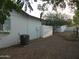 View of the backyard with desert landscaping, fence, A/C unit, and home at 1922 N 21St Pl, Phoenix, AZ 85006