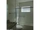 Modern bathroom featuring tiled walls, glass shower doors, and a shower/tub combo at 1922 N 21St Pl, Phoenix, AZ 85006