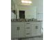 Bathroom vanity with double sinks, granite countertop, modern fixtures, and wooden cabinets at 1922 N 21St Pl, Phoenix, AZ 85006