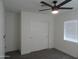 Well-lit bedroom with neutral carpet, a closet with sliding doors, and a window with blinds at 1922 N 21St Pl, Phoenix, AZ 85006