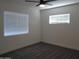 Bright bedroom with neutral carpet, a ceiling fan, and ample natural light from the window at 1922 N 21St Pl, Phoenix, AZ 85006