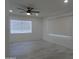 Bright bedroom featuring wood-look tile flooring, a modern ceiling fan, and a window with horizontal blinds at 1922 N 21St Pl, Phoenix, AZ 85006