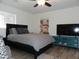 Bedroom with a bed, mounted television, and colorful wall art at 1922 N 21St Pl, Phoenix, AZ 85006