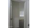View of bedroom, seen through a doorway, with a window and neutral carpet at 1922 N 21St Pl, Phoenix, AZ 85006