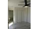 A clean bedroom featuring a sliding door closet, modern ceiling fan, and light at 1922 N 21St Pl, Phoenix, AZ 85006