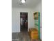 Inviting entryway with a colorful wooden bench and coat rack, seamlessly transitioning to the kitchen at 1922 N 21St Pl, Phoenix, AZ 85006