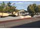 Charming home boasting an eye-catching white brick retaining wall and lush trees adding to its curb appeal at 1922 N 21St Pl, Phoenix, AZ 85006