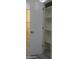 Hallway featuring a doorway leading to a closet with white shelves, providing storage solutions at 1922 N 21St Pl, Phoenix, AZ 85006