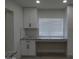 Modern kitchen area featuring white cabinets, granite countertops, and bright lighting at 1922 N 21St Pl, Phoenix, AZ 85006