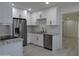 Modern kitchen with white cabinets, granite countertops, stainless steel appliances, and tile backsplash at 1922 N 21St Pl, Phoenix, AZ 85006