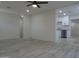 Open-concept living room with a ceiling fan, wood-look floors, and a view into the modern kitchen at 1922 N 21St Pl, Phoenix, AZ 85006