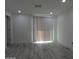 Bright living room with wood-look floors, modern recessed lighting and vertical blinds at 1922 N 21St Pl, Phoenix, AZ 85006