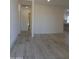 Spacious living room with wood-look tile flooring and neutral paint, offering a bright and airy atmosphere at 1922 N 21St Pl, Phoenix, AZ 85006